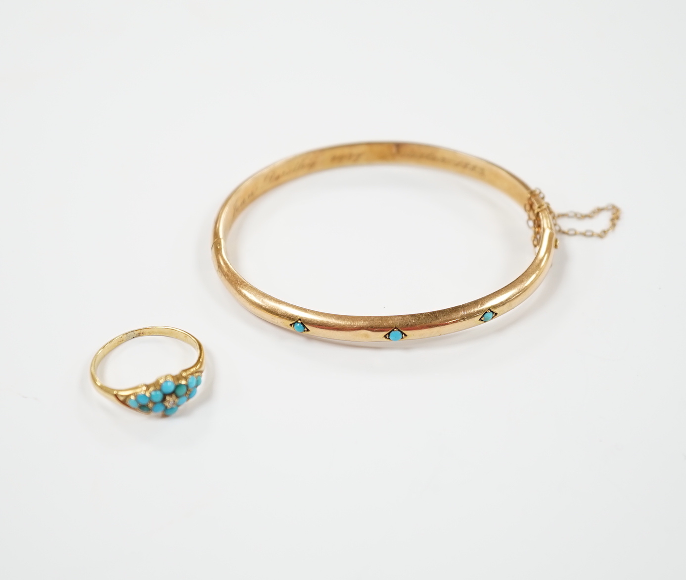 A Victorian yellow metal and three stone cabochon turquoise set hinged bangle, together with a similar yellow metal turquoise and diamond chip cluster set ring, gross weight 10.9 grams.